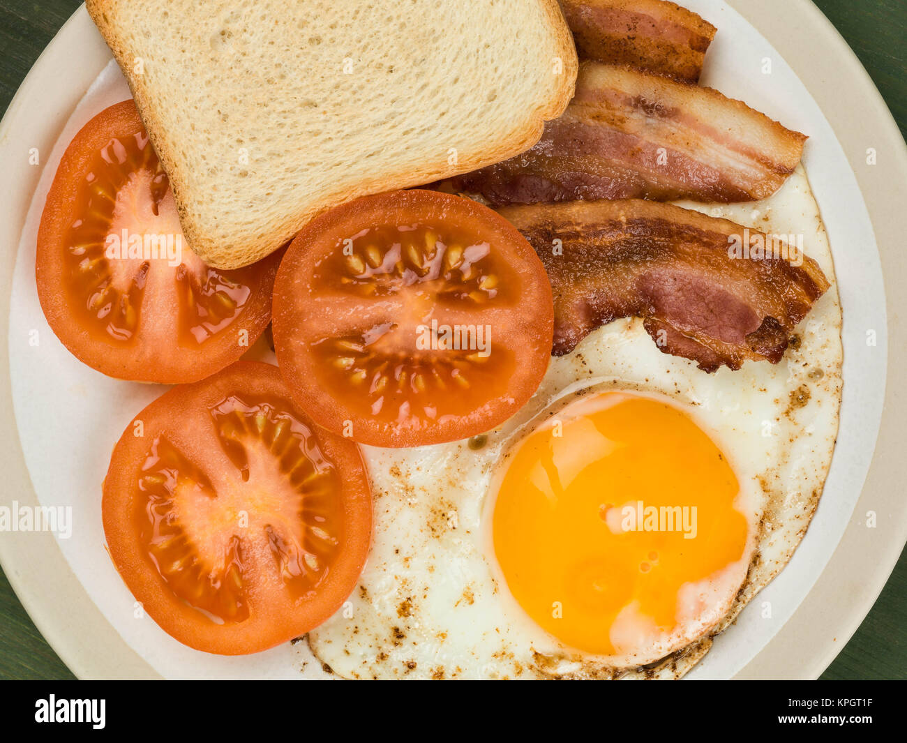 Bacon Egg and Tomato With French Toast Breakfast Food Against a Green