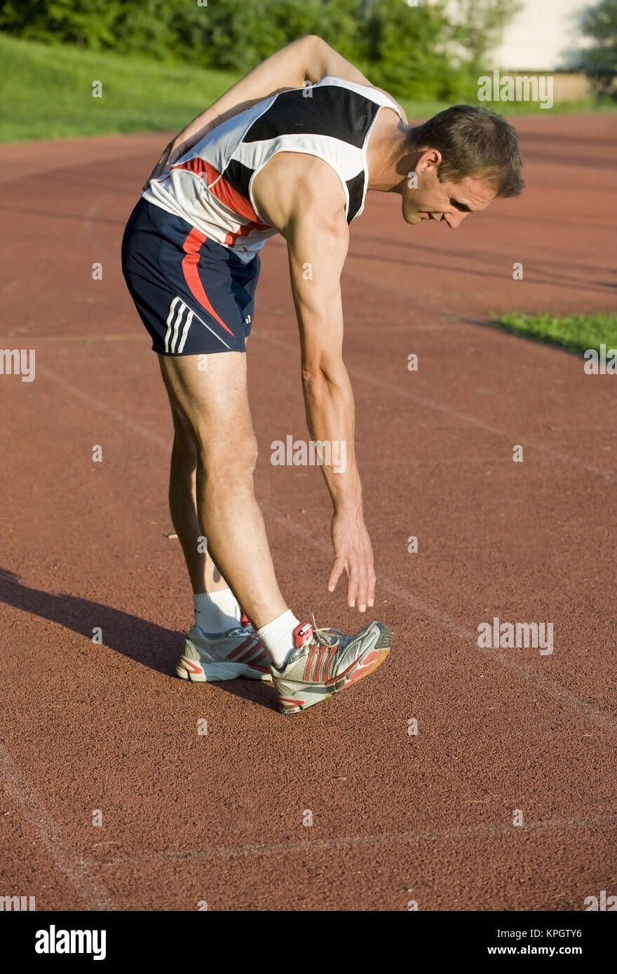 Model released , Sportler beim Stretching - man does stretching Stock Photo