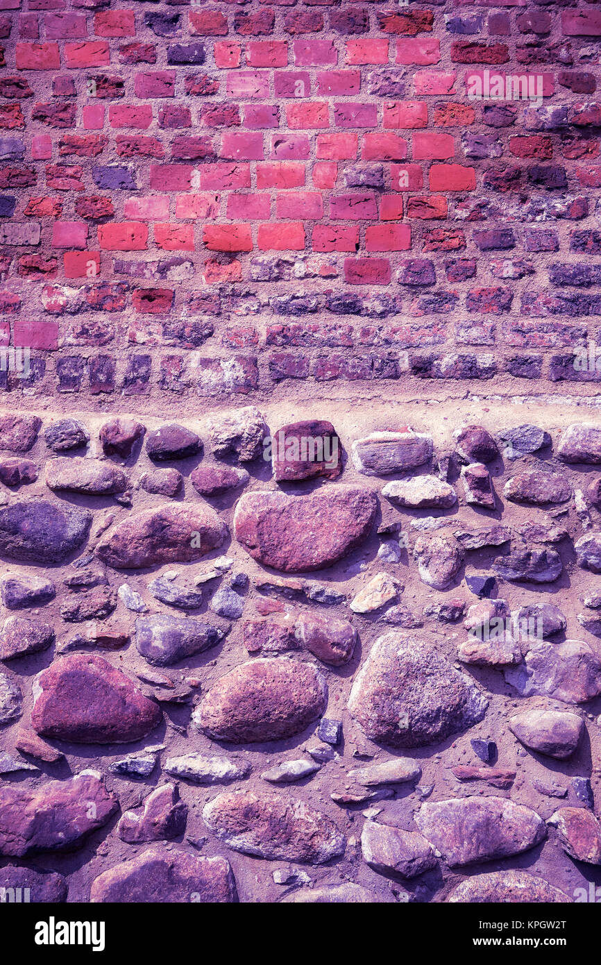 Old brick and stone wall, Ultra Violet color toned image. Stock Photo