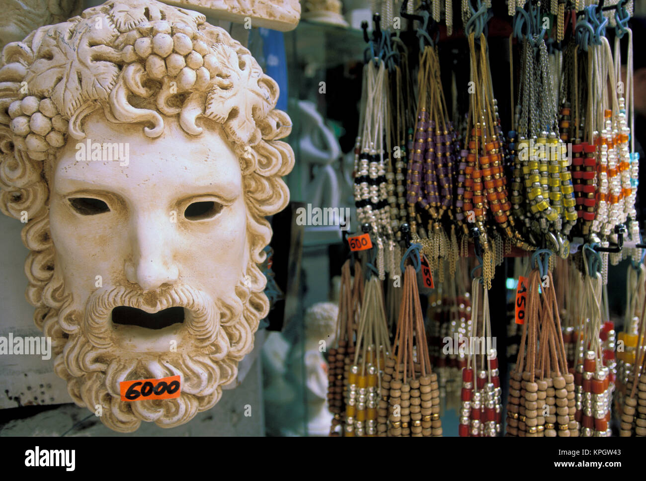 Oia, Santorini, Greece, Mask and strings of beads offered for sale at an outdoor market Stock Photo