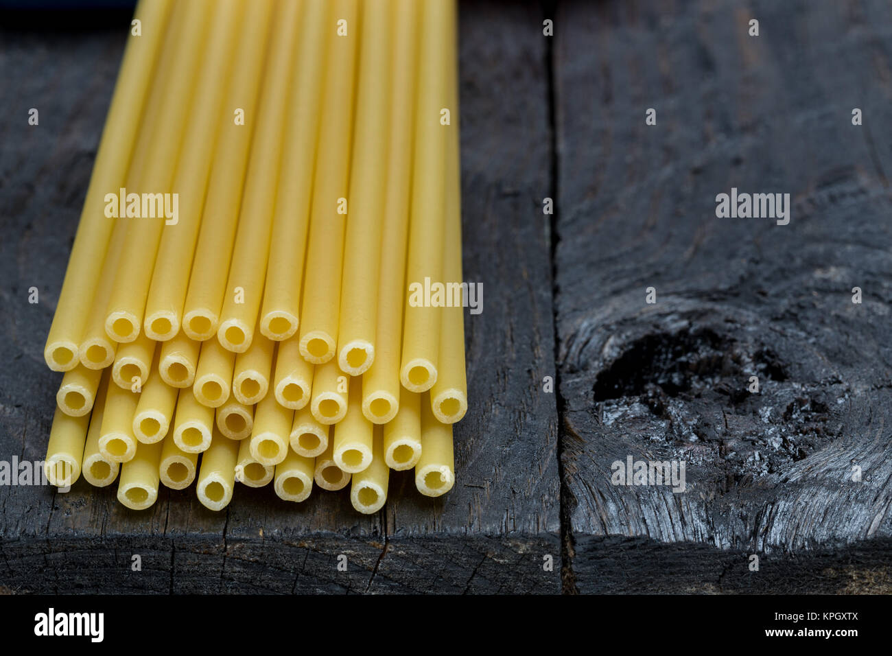 Macaroni pasta on dark rustic wood. Stock Photo