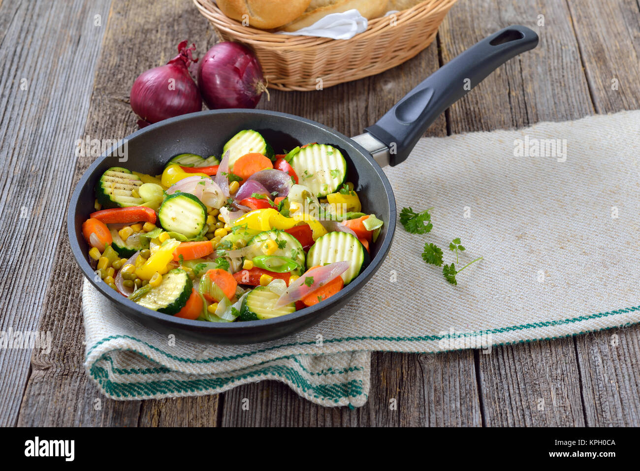 A vegan meal: Mixed short fried vegetables served in a pan Stock Photo