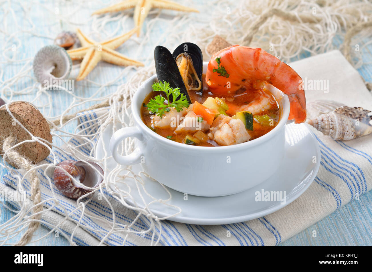 Delicious fish soup with shimps, mussels, fish fillet and vegetables