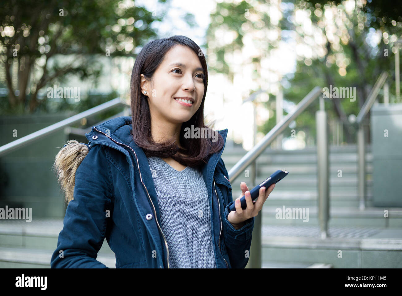 Woman look far away with cellphone Stock Photo Alamy