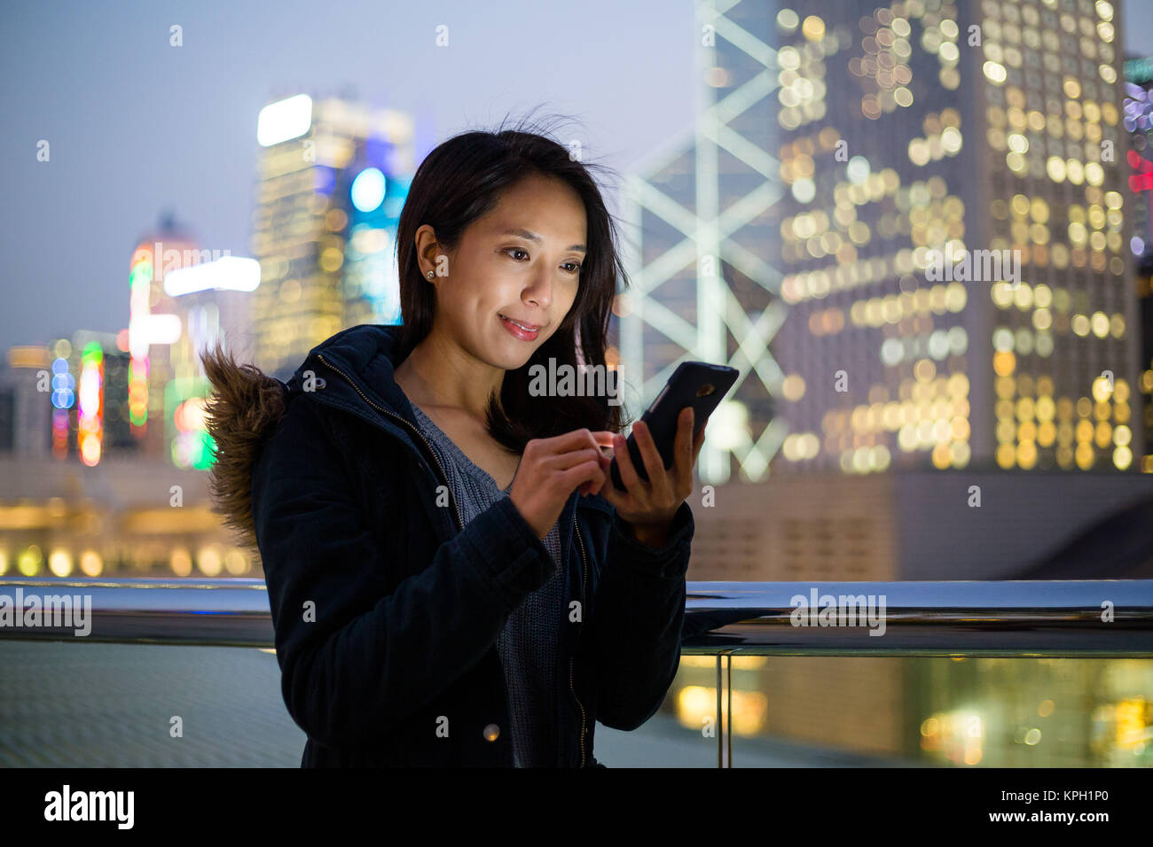 Woman use of mobile phone at Hong Kong Stock Photo - Alamy