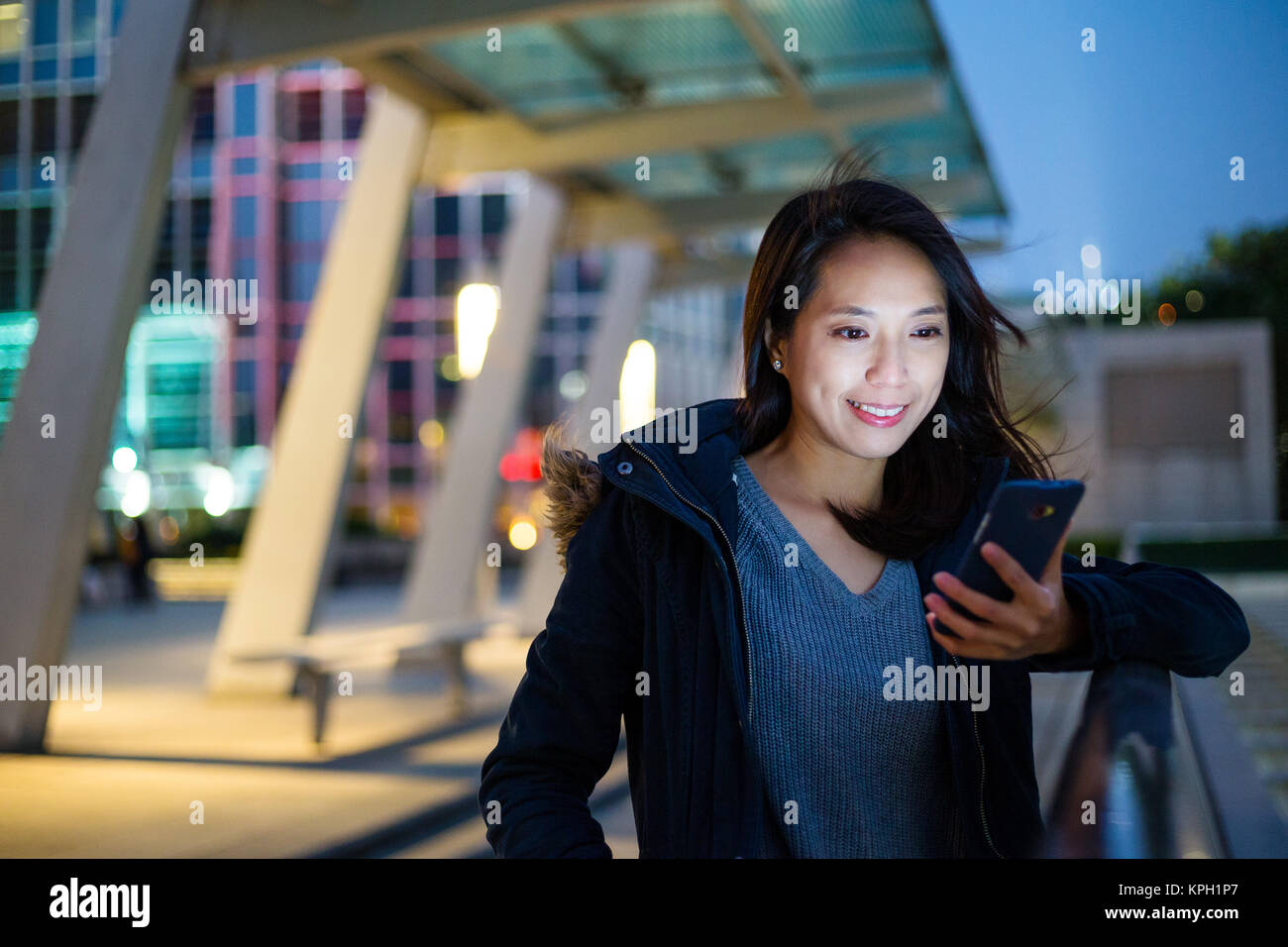 Woman look at mobile phone at night Stock Photo - Alamy