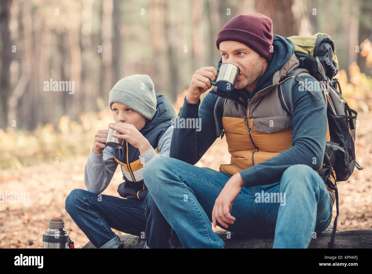 father and son drinking tea in forest Stock Photo - Alamy