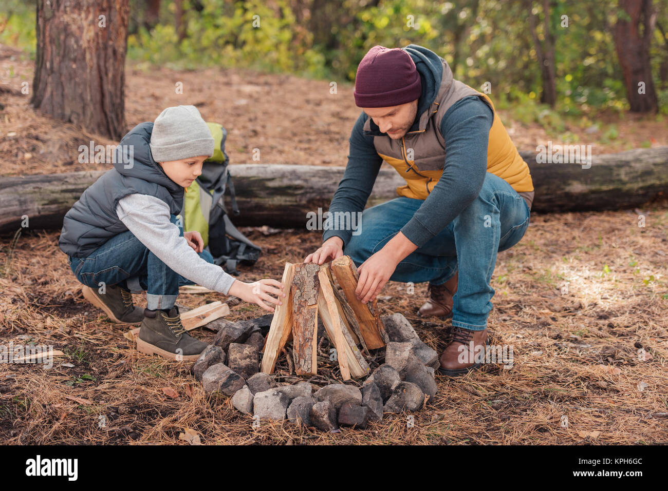 Father and son kindling bonfire Stock Photo Alamy