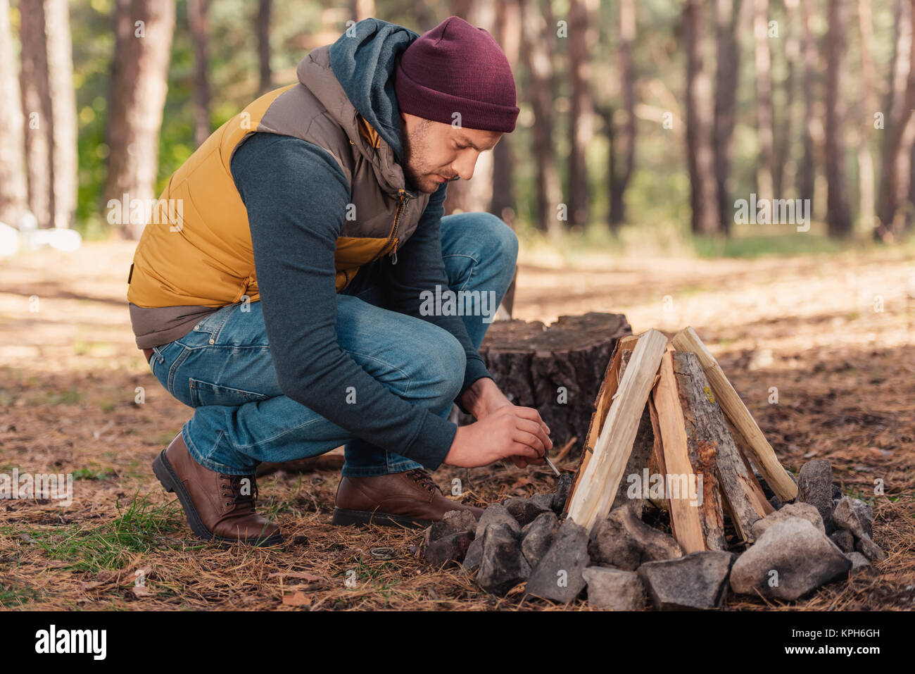man kindling bonfire Stock Photo Alamy