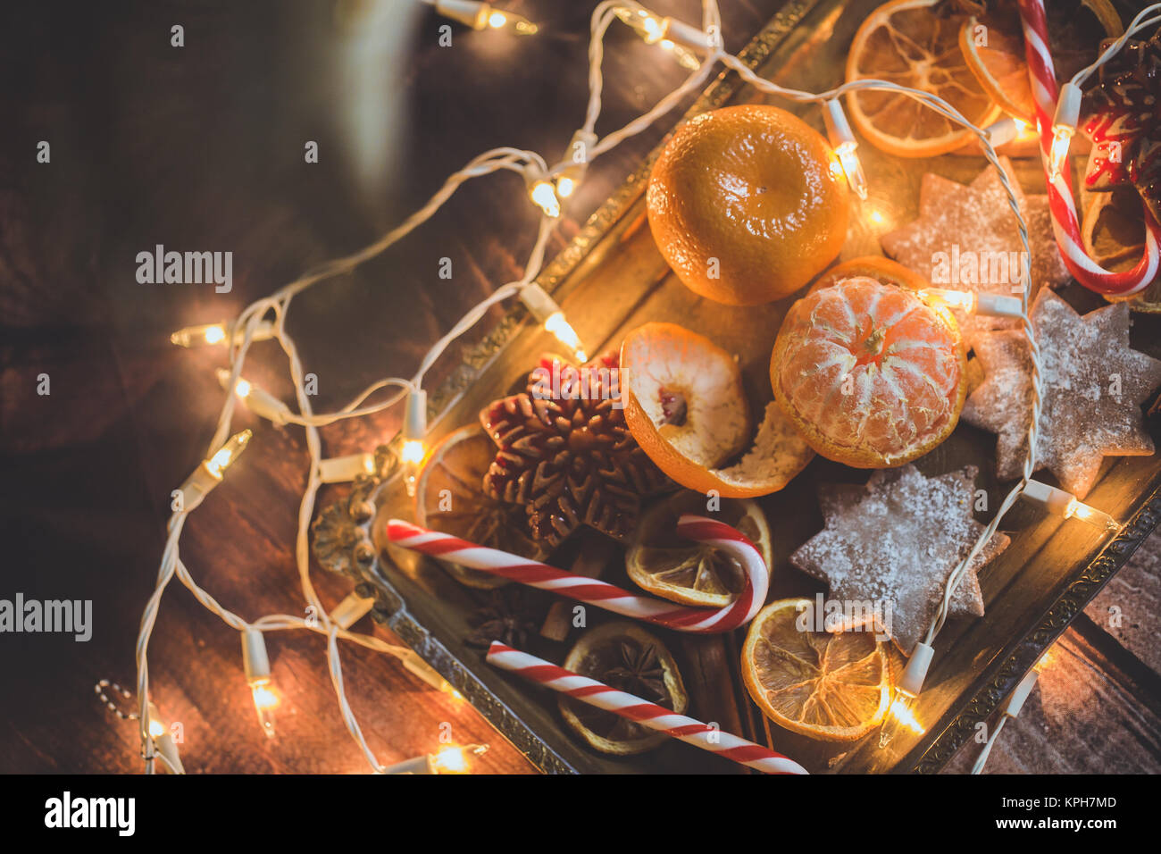 Christmas background with oranges, ornaments, candy and decorations. Free space Stock Photo