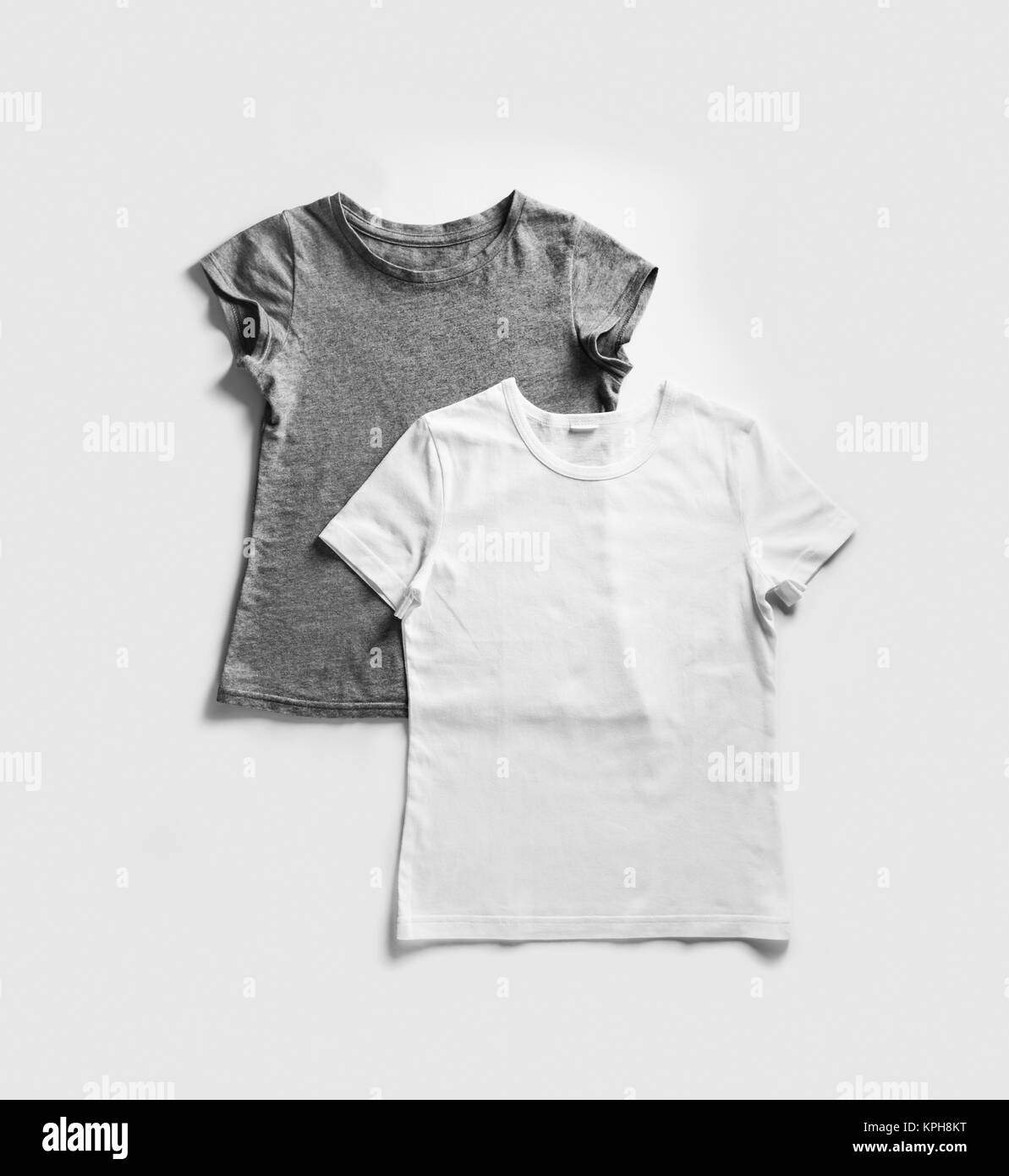 Blank white and gray t-shirts for your design on white paper background. Tshirt template. Flat lay. Stock Photo