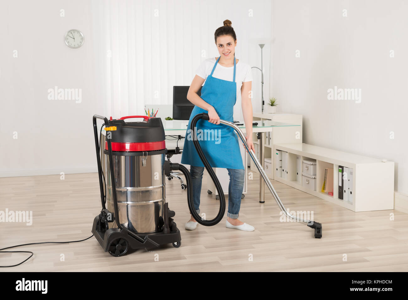 Female Janitor Cleaning Floor With Vacuum Cleaner Stock Photo Alamy