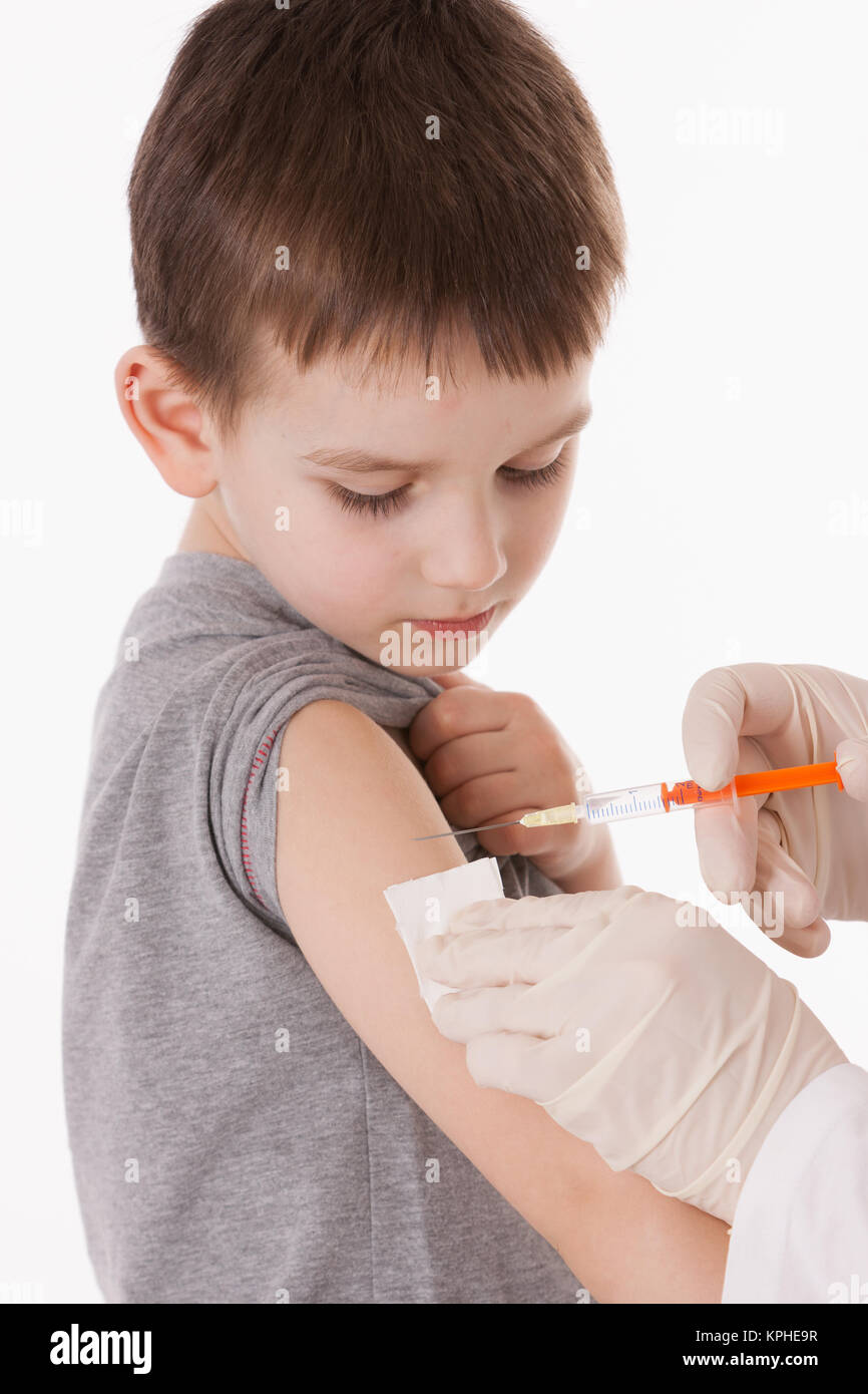 Doctor giving a child injection in arm on isolated image. Stock Photo