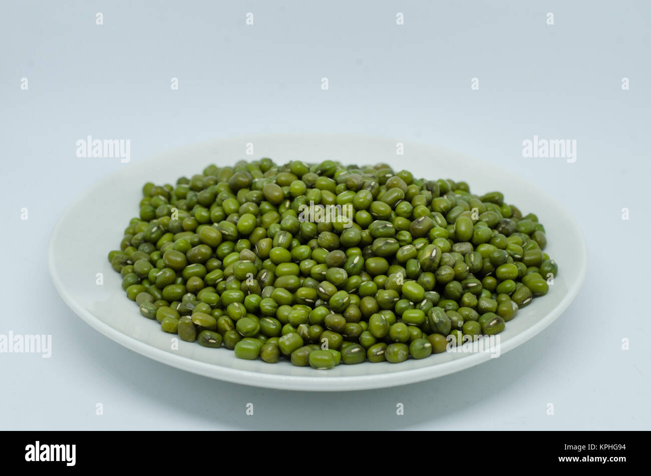 Mung beans in plate isolated on white background. also known as moong bean, green gram, green bean. its in legume family species Stock Photo