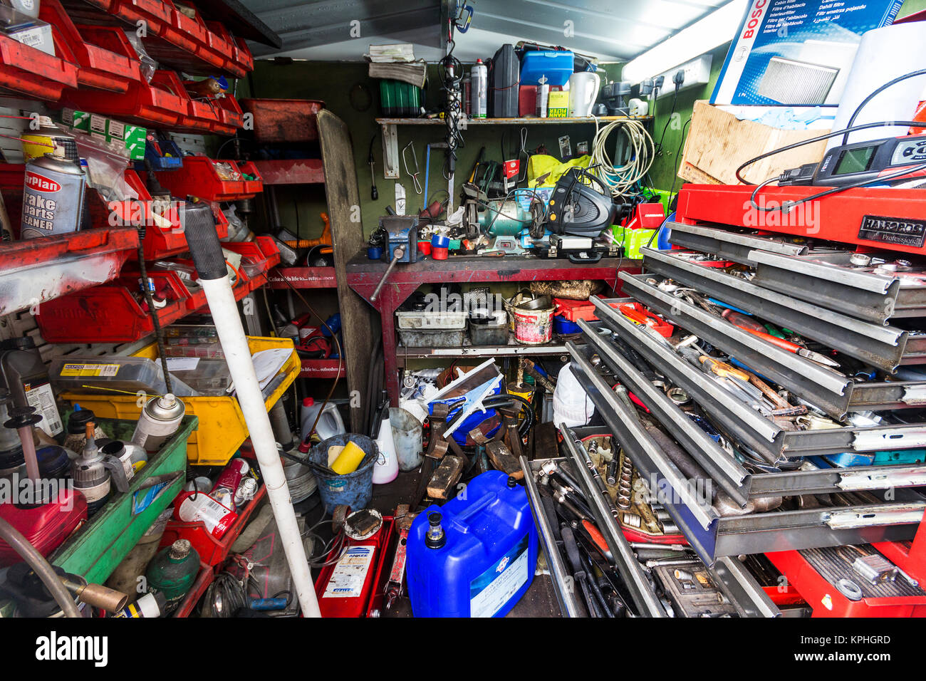 Very small mechanics with various tools equipment and consumables displaying a random