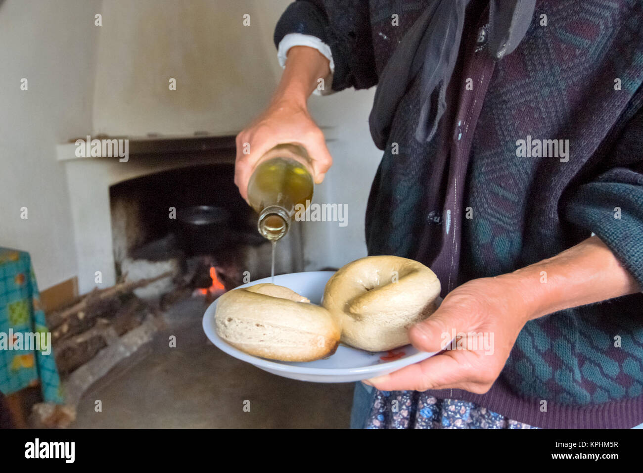 Greece, Aegean Islands, Karpathos island,a woman from Olympos, offers as a welcome bread drizzled with olive oil Stock Photo