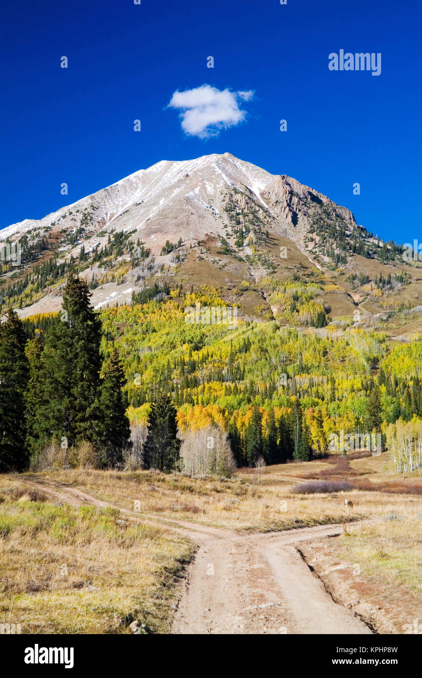 USA, Colorado, Mt. Crested Butte, Fork in the Country Backroad with Mountain in Background Stock Photo