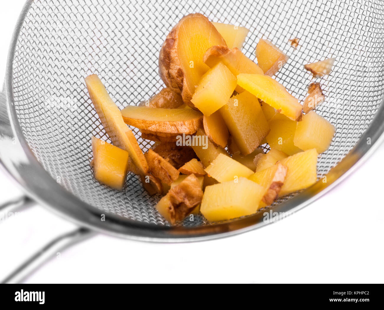 Cut ginger in sieve Stock Photo