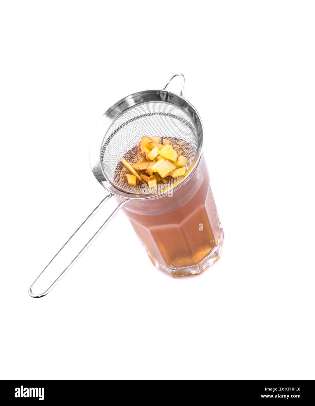 Ginger in the sieve and a glass of ginger tea Stock Photo