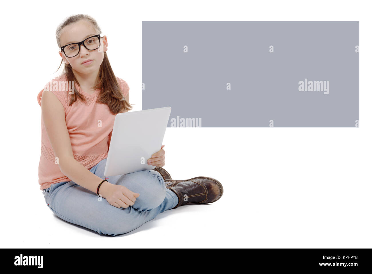 Beautiful preteen girl with a tablet computer. Stock Photo