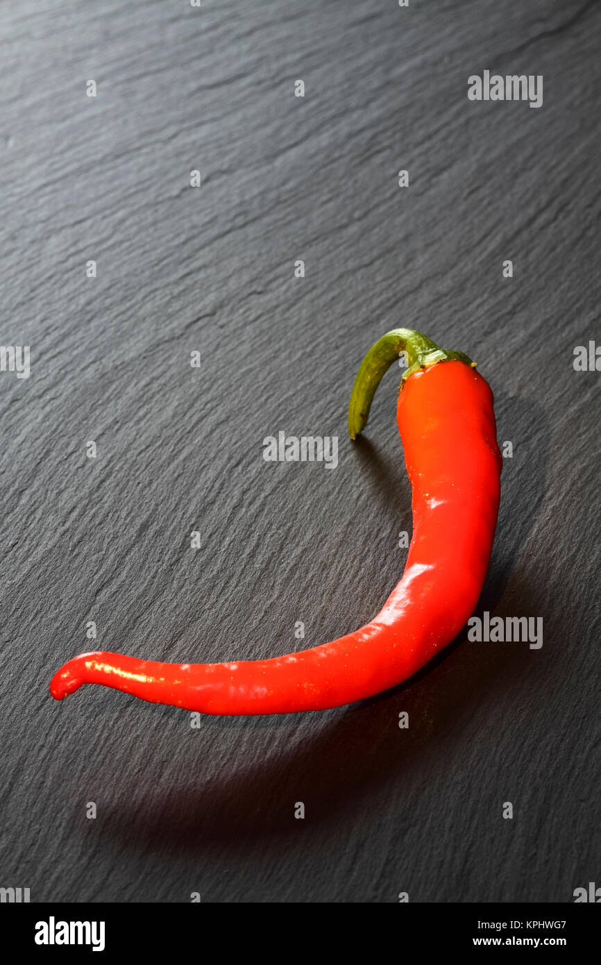 Red organic chilli pepper Laid on a slate platter Stock Photo