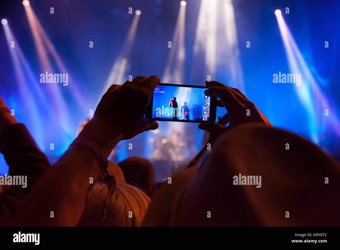Person capturing a video  on a mobile phone at a music festival. Stock Photo