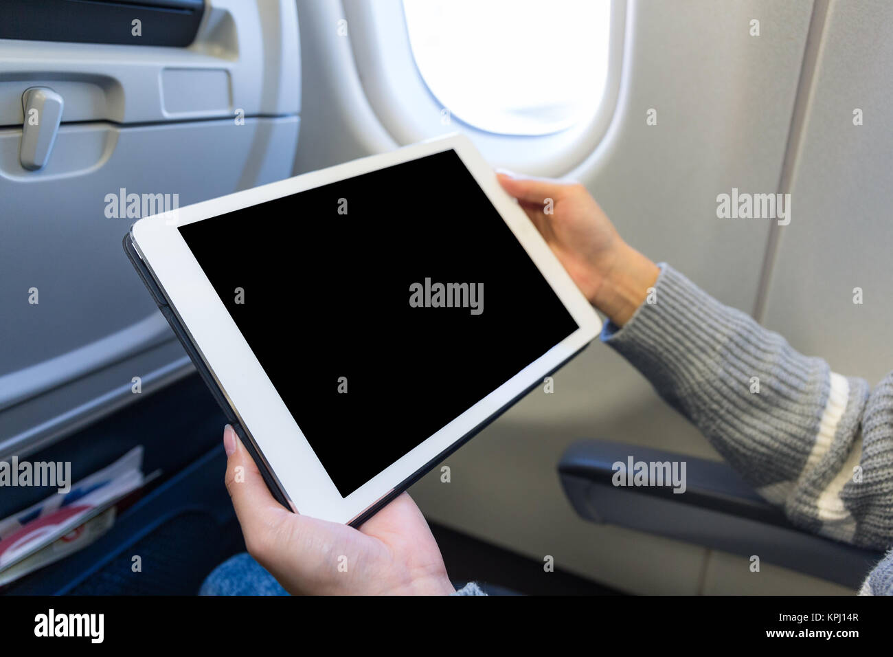 Woman use of the digital tablet in plane Stock Photo Alamy