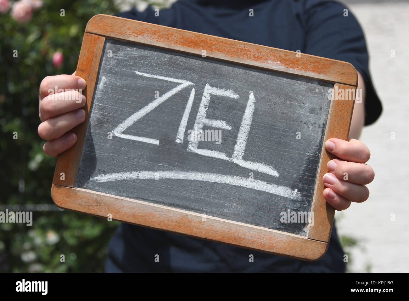 ZIEL (target/ finish in German) written with chalk on slate shown by