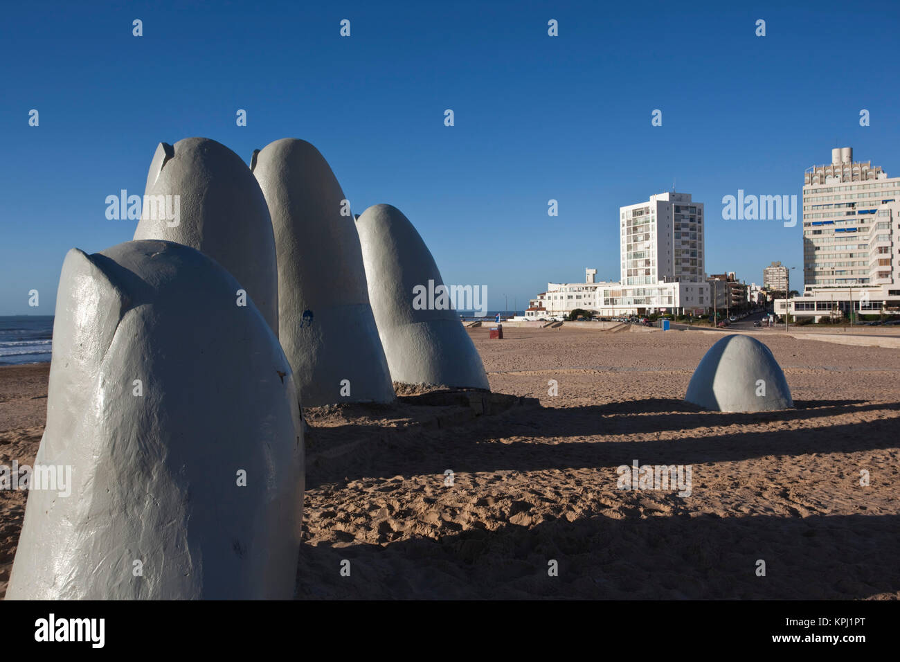 Uruguay, Maldonado Department, Punta del Este. Playa Brava: Chilean Artist Mario Irarrazabal's La Mano en la Arena (Hand in the Sand) sculpture. Stock Photo