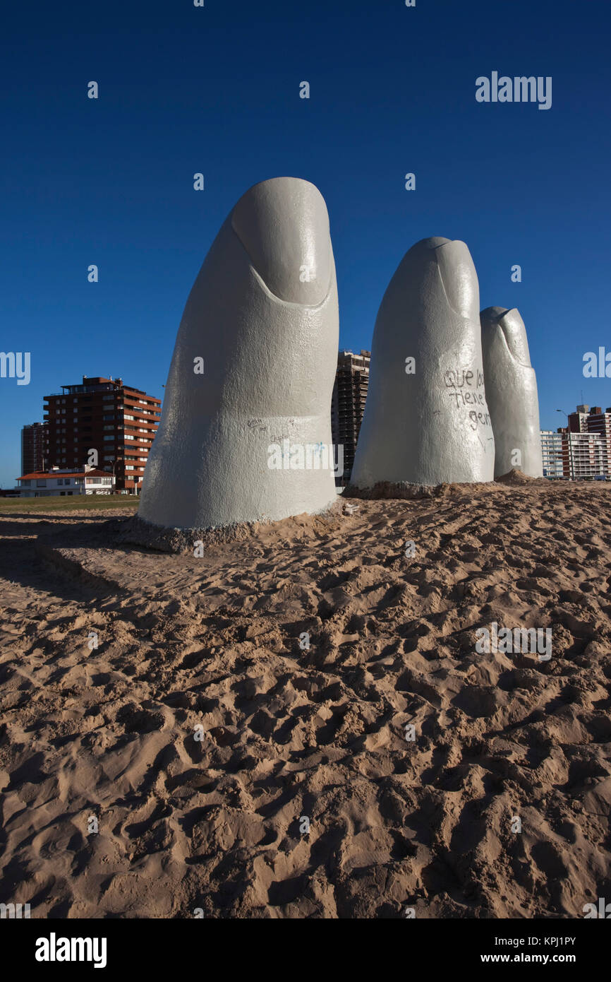 Uruguay, Maldonado Department, Punta del Este. Playa Brava: Chilean Artist Mario Irarrazabal's La Mano en la Arena (Hand in the Sand) sculpture. Stock Photo