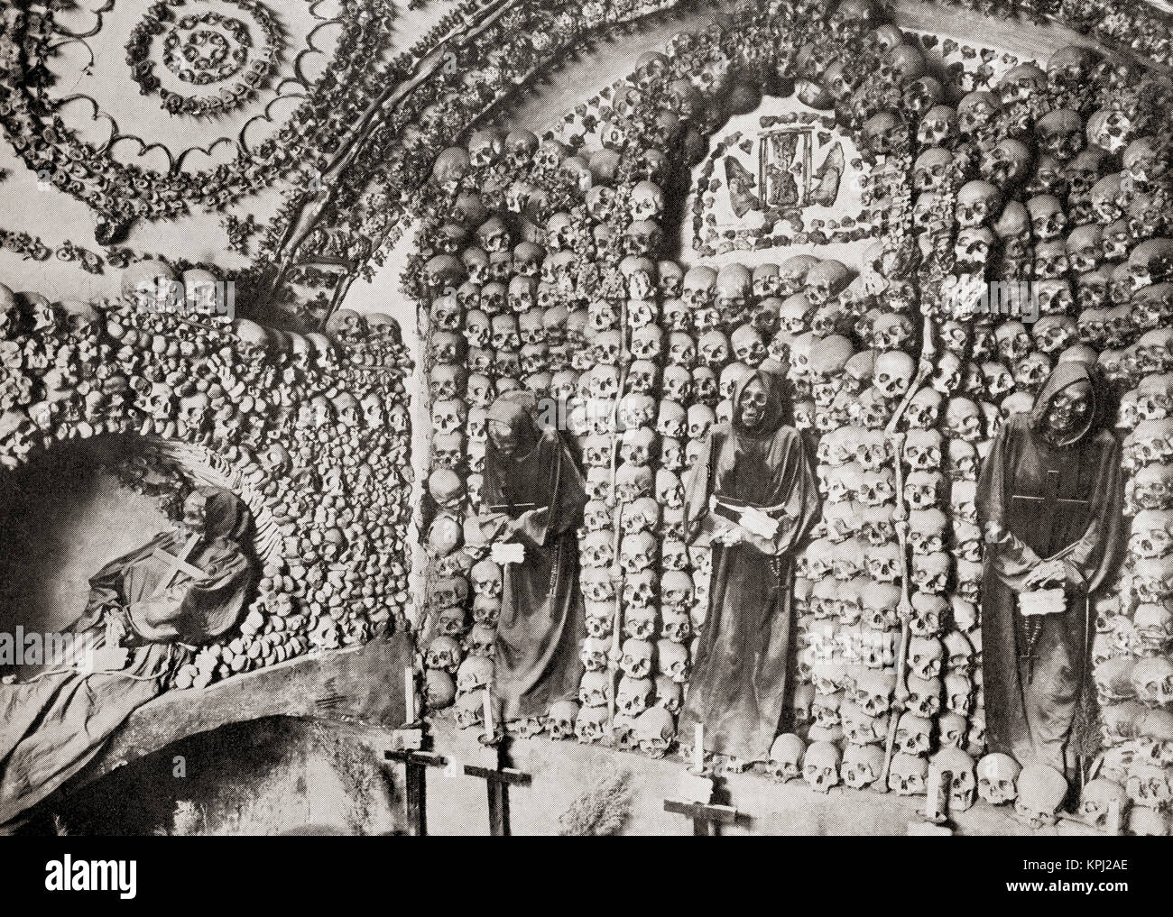 The Capuchin Crypt, a small space comprising several tiny chapels located beneath the church of Santa Maria della Concezione dei Cappuccini on the Via Veneto, Rome, Italy, lined with the skeletal remains of 3,700 bodies believed to be Capuchin friars.  From The Wonders of the World, published c.1920. Stock Photo