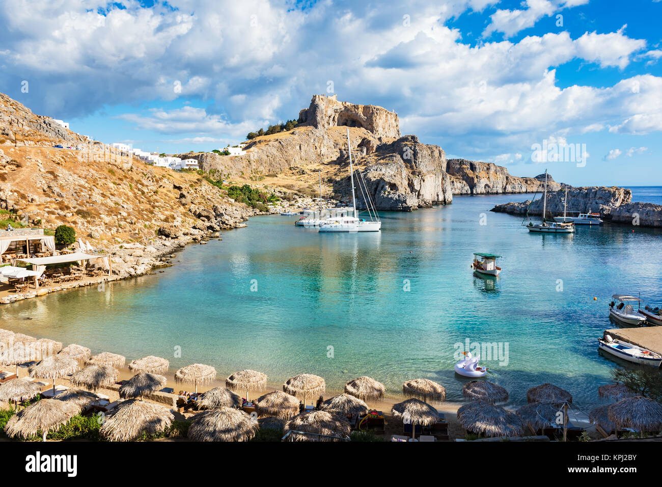 Beautiful beach in St. Paul´s bay, Lindos acropolis in background ...