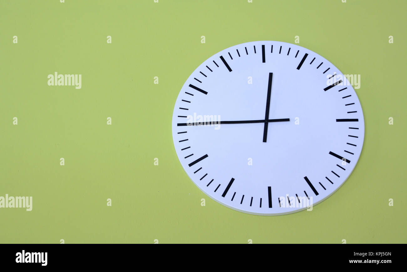 Isolated clock.Wall clock with green background Stock Photo - Alamy