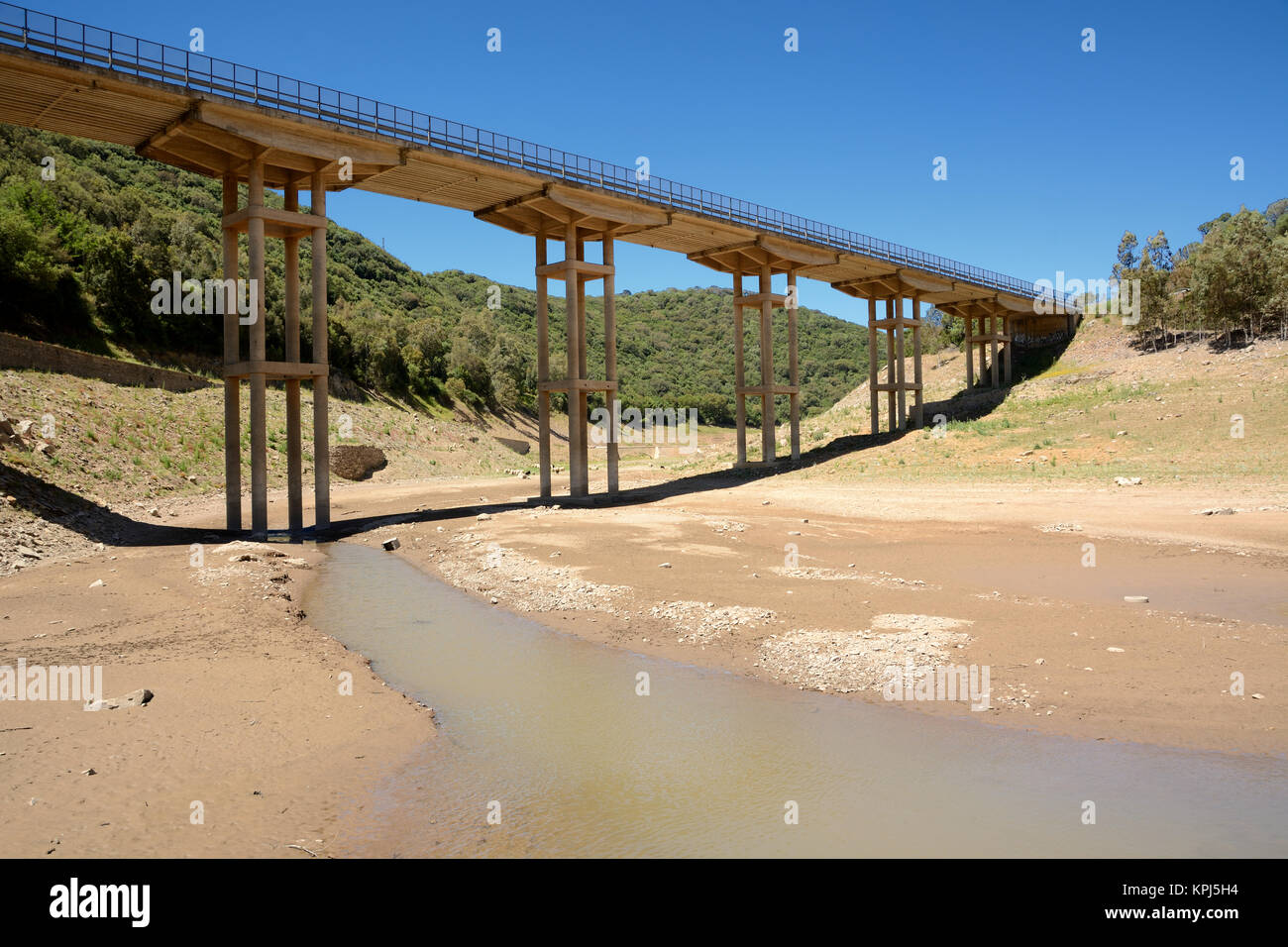 Dry lake under a road bridge. Example of climate changing Stock Photo
