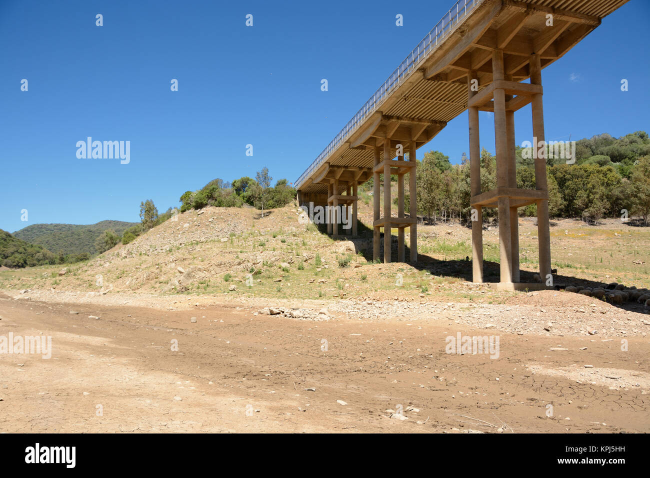 Dry lake under a road bridge. Example of climate changing Stock Photo