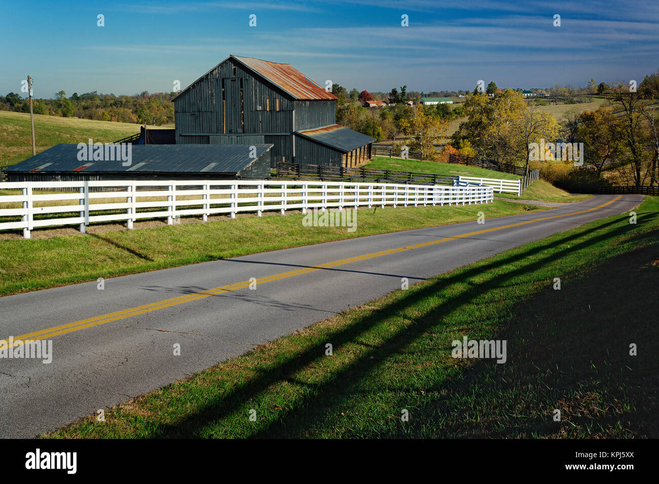 Rural road through Bluegrass region of Kentucky in autumn season near Lexington, Kentucky Stock Photo