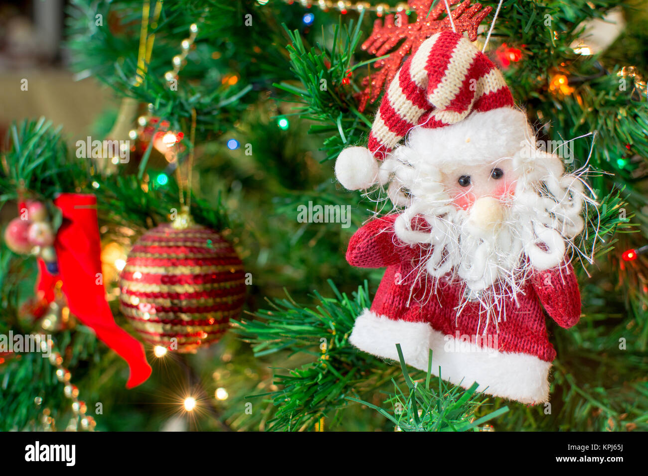 Jingle bell, Christmas tree branches with blurred background. Stock Photo