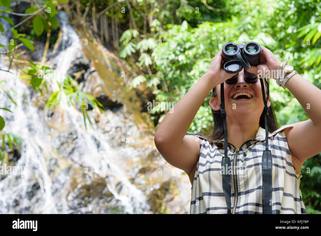 Girl using binoculars in forest Stock Photo Alamy