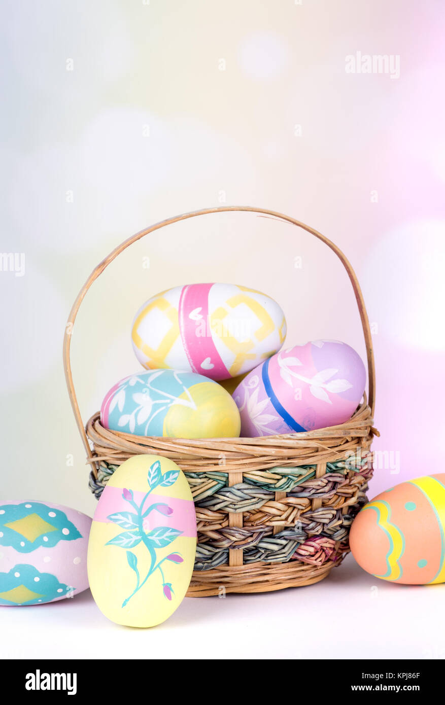 Painted Easter eggs and basket on a colorful background Stock Photo - Alamy