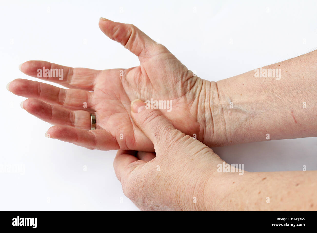 an elderly woman has pain in his hands Stock Photo