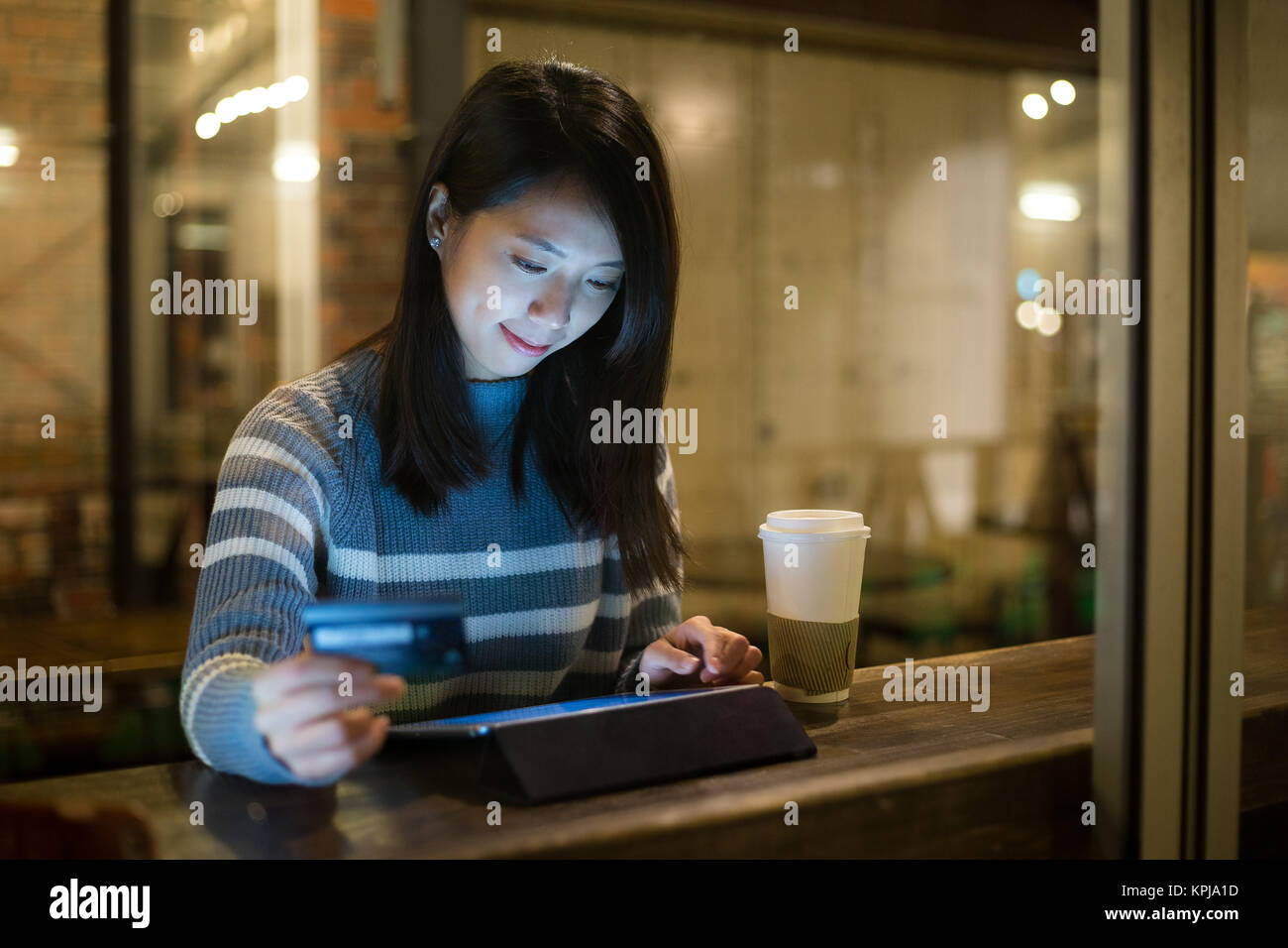 Asian young woman using tablet for online shopping in cafe Stock Photo ...