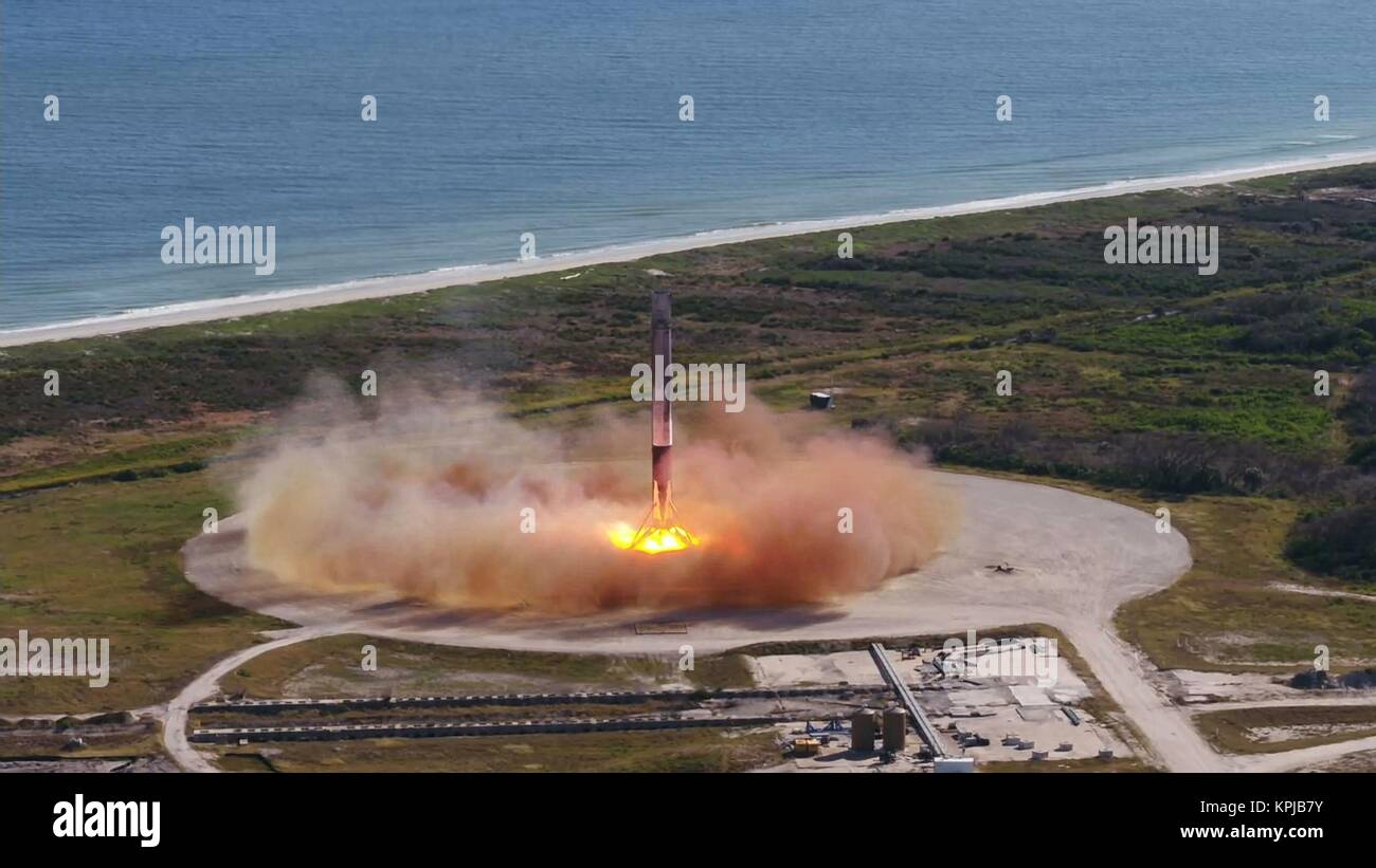 Cape Canaveral, Florida. 15th December, 2017. The SpaceX Falcon 9 first stage rocket successfully lands on Landing Zone 1 after carrying the Dragon capsule into Earth Orbit at the Cape Canaveral Spaceport December 15, 2017 in Cape Canaveral, Florida. The Dragon capsule is on a resupply run to the International Space Station and is the first time SpaceX launched a pre-flown rocket and spacecraft on a NASA mission. Credit: Planetpix/Alamy Live News Stock Photo