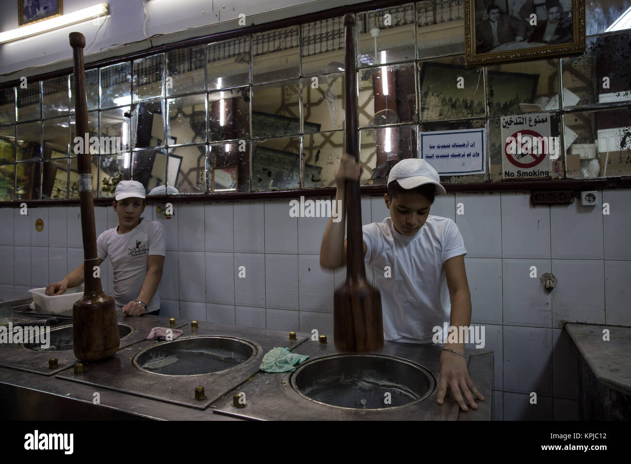 Damascus, Syria. 28th Oct, 2017. Young men pound ice-cream in Bakdash, a famous ice-cream parlour in which has been open in Al-Hamidiyah Souq in the old city of Damascus since 1885.Despite the ongoing conflict in Syria, the life of Damascus still carries on relatively peaceful. Damascus is the capital city of the war torn Syria, it is under control by the official Syrian government led by president Bashar al-Assad. Credit: Sally Hayden/SOPA/ZUMA Wire/Alamy Live News Stock Photo