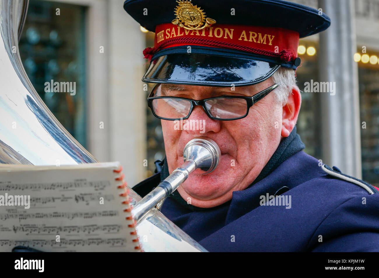 Glasgow, Scotland, UK. 16th December, 2017. As thousands of shoppers flocked to Glasgow city centre and in particular Buchanan Street also known as Glasgow's Style Mile many entered into the seasonal spirit and enjoyed the entertainment from the street musicians and buskers. KEVIN JEFFERSON a member of the Govan Branch of the Salvation Army playing the tuba Credit: Findlay/Alamy Live News Stock Photo