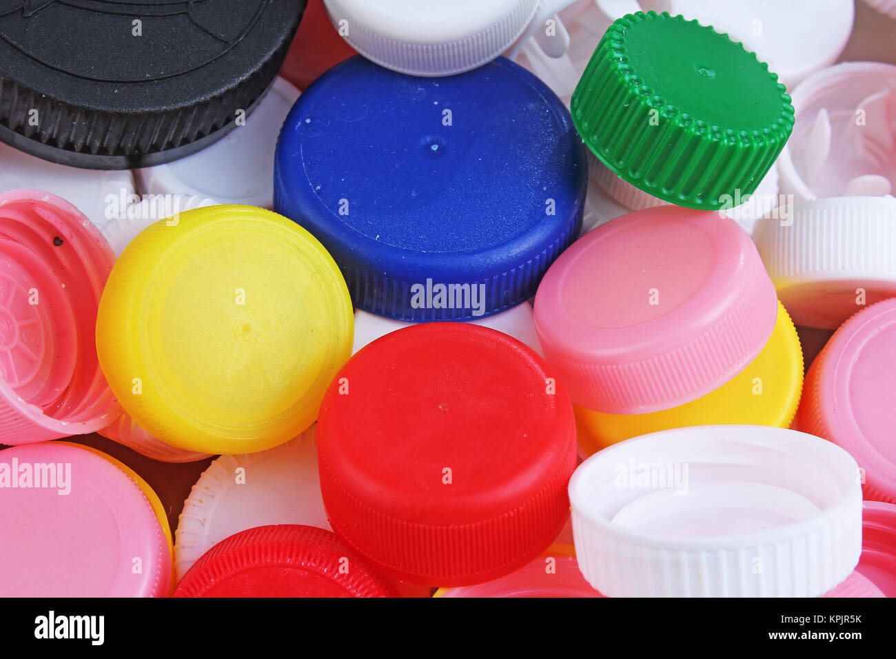 Collect plastic bottle caps. Closeup shot of stack of recyclable