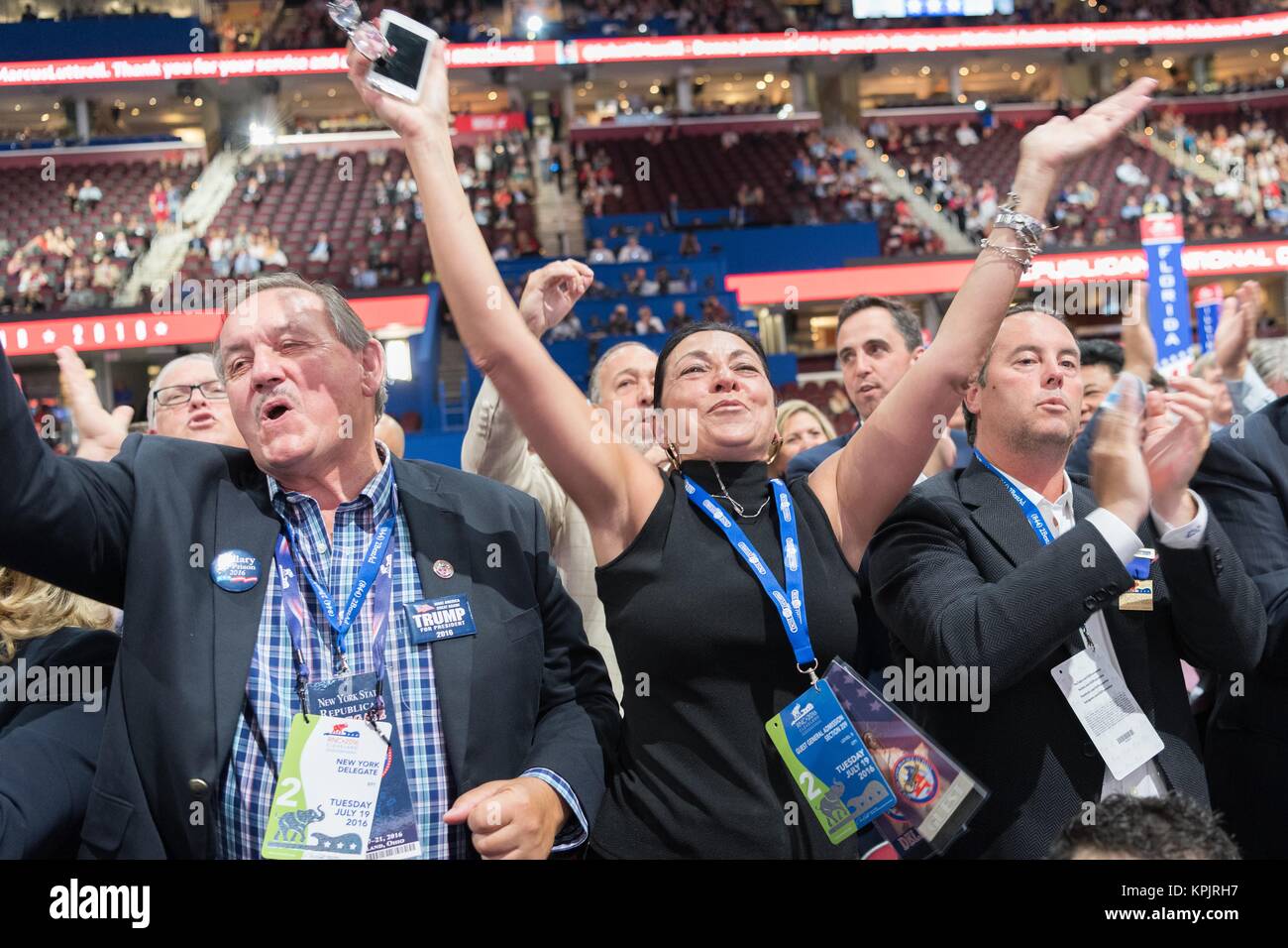 New York delegates celebrate the nomination of Donald Trump during the second day of the Republican National Convention July 19, 2016 in Cleveland, Ohio. The delegates formally nominated Donald J. Trump for president after a state by state roll call. Stock Photo