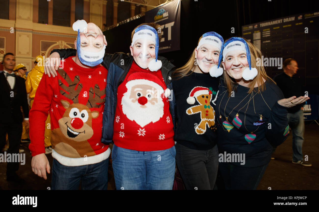 Darts fans wearing Phil Taylor masks and Christmas jumpers on Christmas  Jumper Day before the start of play on day two of the William Hill World  Darts Championship at Alexandra Palace, London