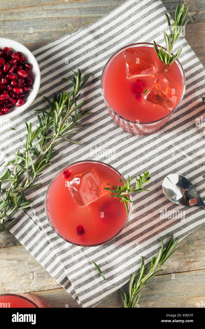 Homemade Boozy Pomegranate Cocktail with Rosemary and Vodka Stock Photo