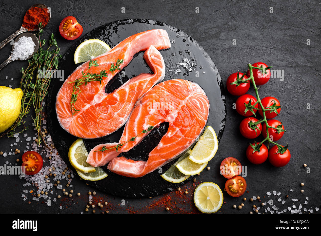 Fresh raw salmon red fish steaks on black background, top view Stock ...