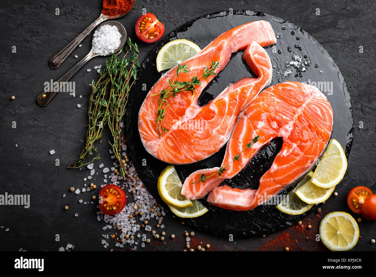 Fresh raw salmon red fish steaks on black background, top view Stock ...